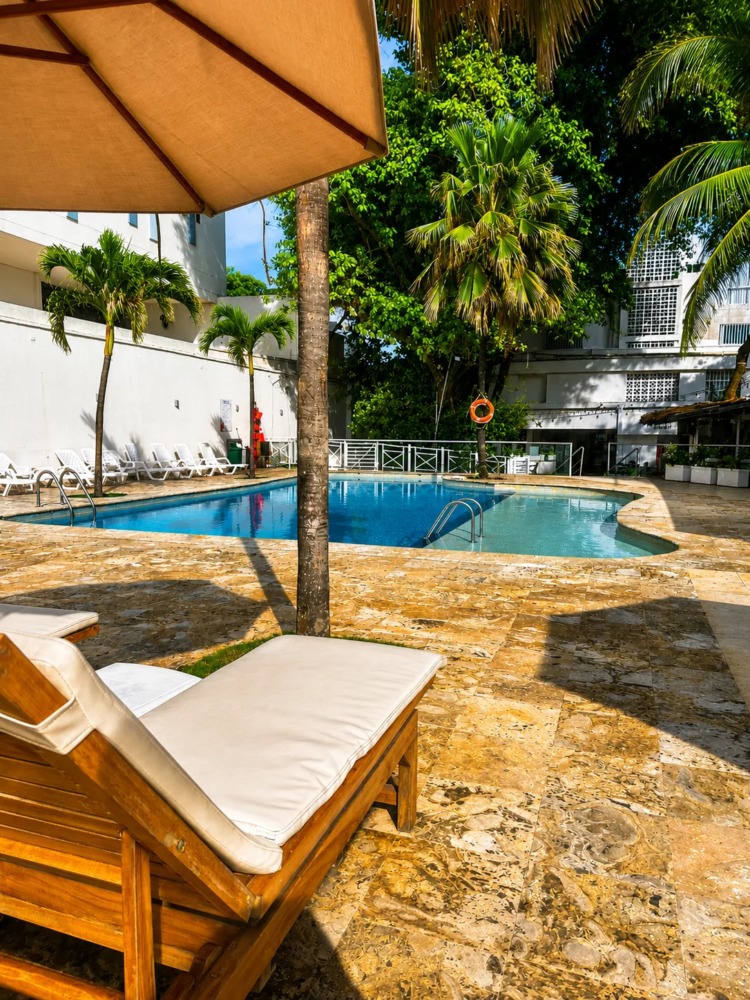 Wooden sun loungers by the pool